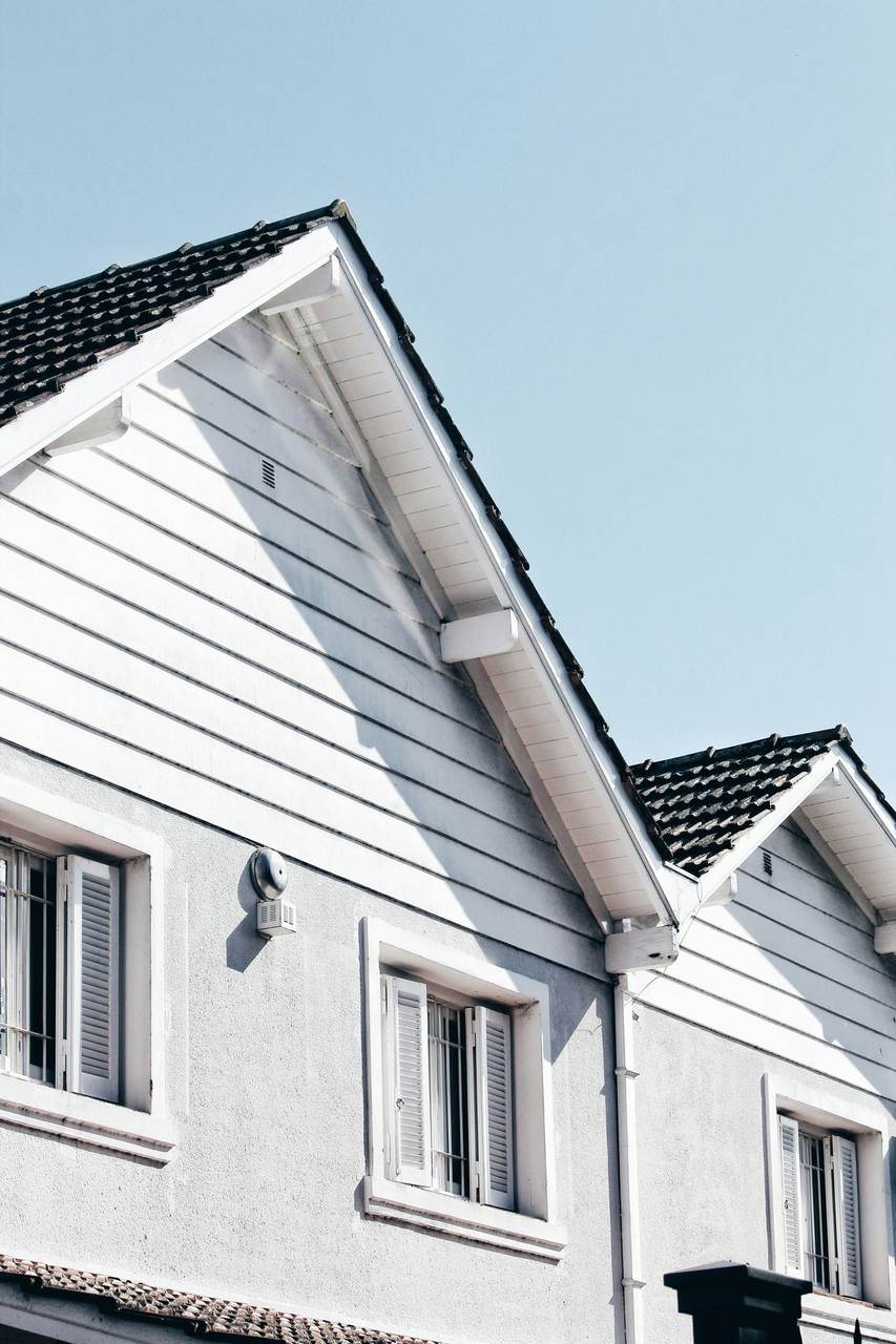 Freshly painted white home with a dark tiled roof