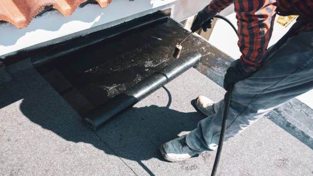 Emergency waterproofing repair being applied to a flat roof edge