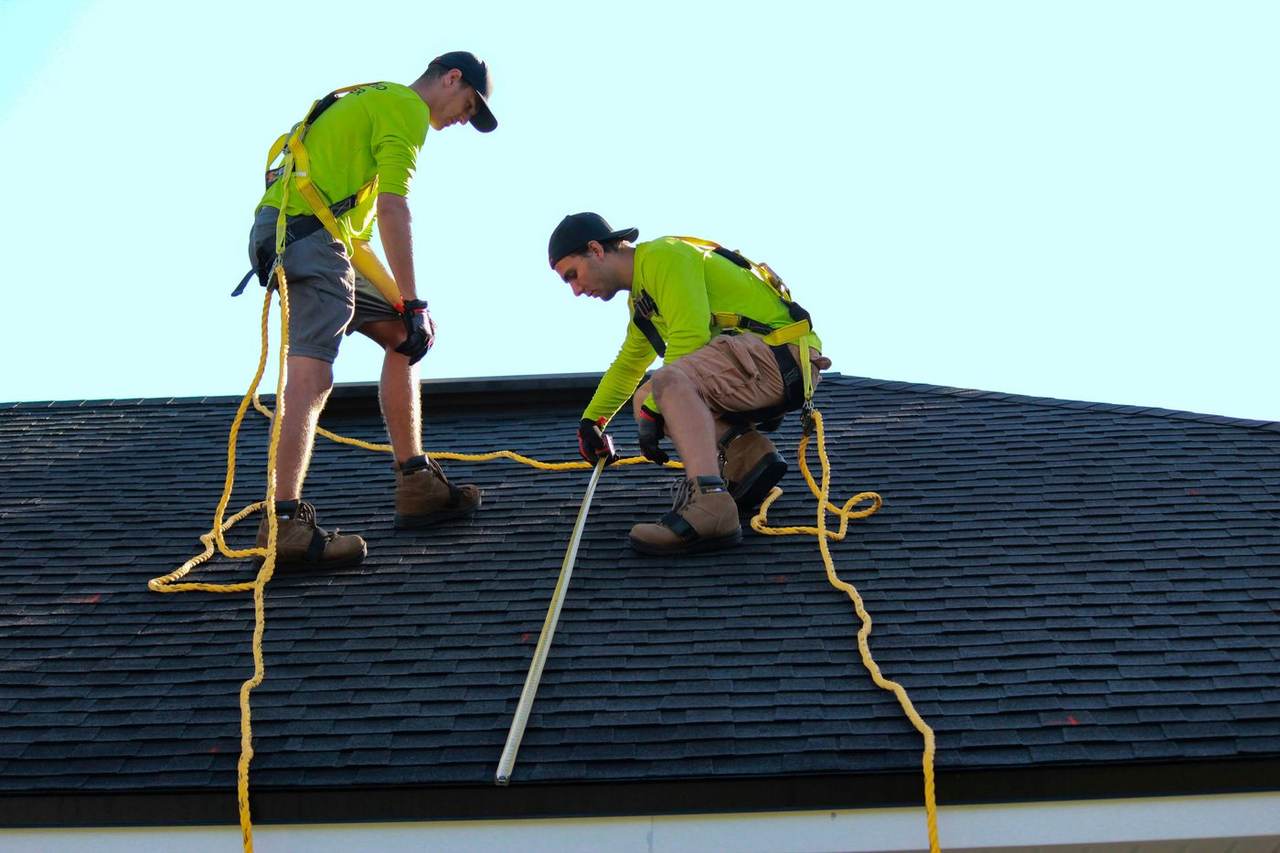 Superior Waterproofing team measuring a roof before starting a waterproofing job